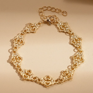 Detailed close-up of hollow heart-shaped links on a vintage gold bracelet with lobster clasp