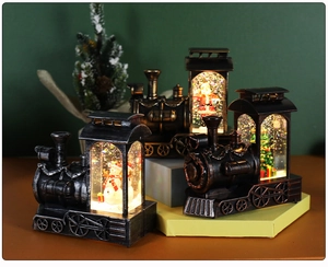 Close-up of vintage bronze train lanterns with Santa figures and glowing glitter liquid