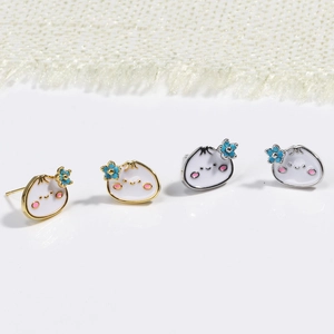 Detail of cute white enamel bao bun earrings with pink cheeks and blue flowers
