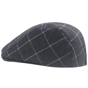 Close-up of grey plaid beret hat with tweed texture and side metal buckle detail