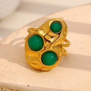 Macro detail of 18K gold plated hammered ring with three green gemstone inlays
