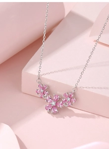 Close-up of S925 silver necklace with three pink zircon flower-shaped pendants
