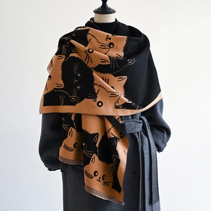 Detail of soft double-sided scarf with cute cat face patterns and short fringed edges