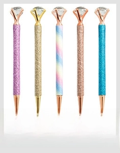 Detail view of colorful glitter metal pens with large crystal diamonds on top