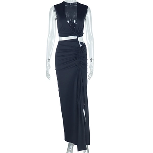 Detail of black two-piece set featuring a halter deep V-neck crop top and ruched slit maxi skirt