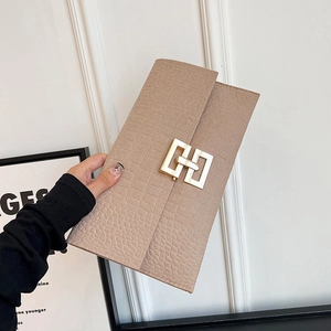 Minimalist beige envelope clutch bag with crocodile texture and golden geometric lock