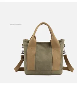 Detail view of reinforced bottom and smooth protective base of army green canvas tote bag