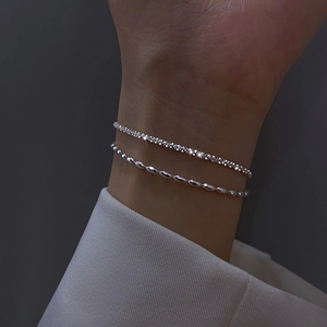 Sparkling silver layered bracelet with crystal beads and rhinestones on woman's wrist