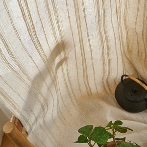 Japanese style beige linen striped curtain fabric in a cozy tea room setting