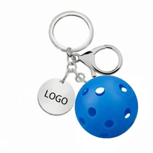 Blue pickleball keychain with stainless steel chain and round metal tag on white background