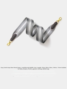 Close-up of 5cm wide grey striped woven strap with genuine leather and gold spring hook
