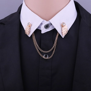 Detailed view of golden wing collar pin with double chains and white rhinestones decoration