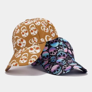 Detailed close-up of skull print baseball caps in khaki and black with gradient patterns
