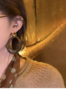 Close-up of model wearing retro resin teardrop earrings with gold metal studs
