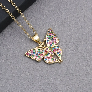 Detailed close-up of a golden butterfly pendant with colorful zircons and an O-chain