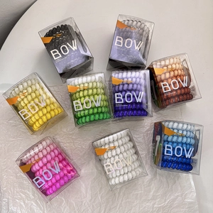 8-pack of colorful spiral hair ties in transparent boxes for damage-free styling