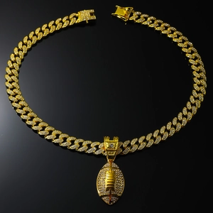Close-up of hip-hop gold Cuban chain with iced out rugby pendant and encrusted square clasp