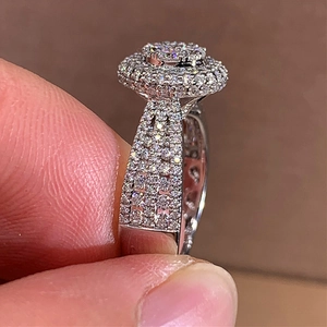 Luxury round cut sparkling diamond ring with double halo and pave set band in silver