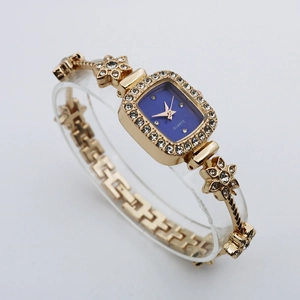 Macro detail of square blue dial with crystal bezel and floral bracelet watch design