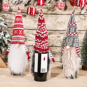 Three Christmas gnome wine bottle covers with knitted hats and long white fiber beards