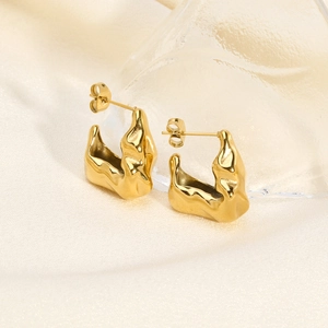 Detailed view of French vintage gold V-shaped irregular earrings with molten metal texture