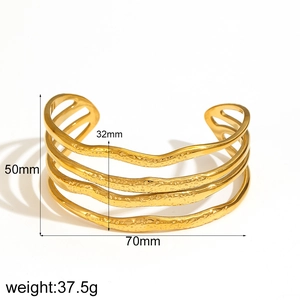 Detailed view of wide gold-finish floral hammer texture open bangle dimensions