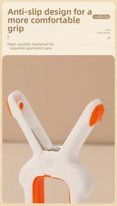 Macro detail of windproof quilt clip showing orange non-slip grip dots and strong spring