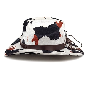 Western cow print cowboy hat with upturned brim and decorative brown leather band