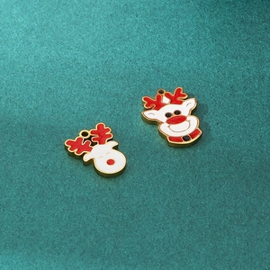 Close-up of two red and white enamel Christmas reindeer pendants with golden edges