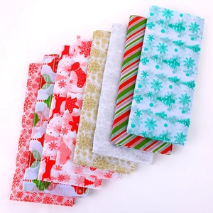 Close-up of assorted festive Christmas tissue papers with snowflakes and reindeer patterns