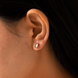 Detailed close-up of a gold-plated stainless steel stud earring set with white zircon
