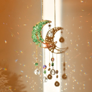 Handmade moon tree of life sun catcher with green stones and crystal prisms hanging on wall