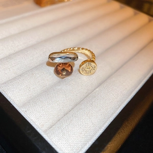Macro shot of gold dragon ring with clover zircon and amber stones in a jewelry box