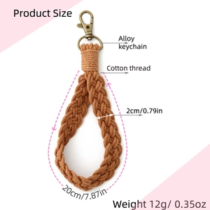 Detail view of brown woven cotton keychain with alloy ring and product size markings