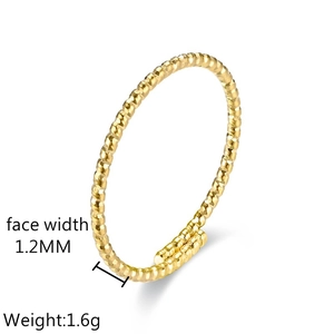 Macro detail of 1.2mm wide twisted gold titanium ring with adjustable open design