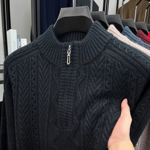 Detail showing elastic cable knit fabric texture and half-zip stand collar on men sweater