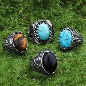 Macro view of vintage stainless steel rings with turquoise and tiger eye stones