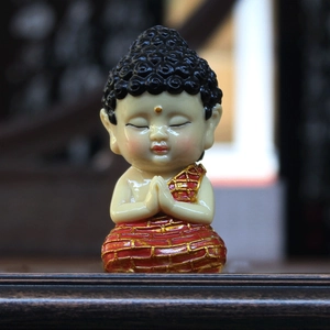 Meditating Buddha monk figurine in red and gold robes for car dashboard and home decor