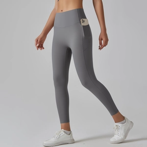 Detail of high waisted yoga leggings with side pockets showing mobile phone storage