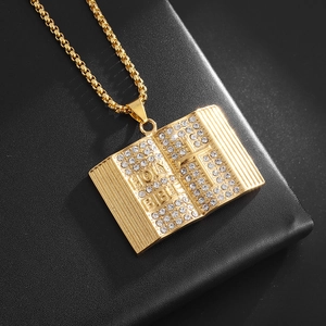 18K gold-plated Holy Bible pendant necklace with stones on black leather background
