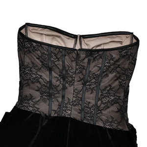 Detail of floral black lace corset with mesh paneling and vertical boning structure
