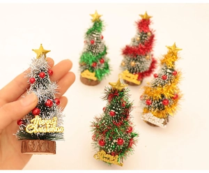 Miniature Christmas cedar trees with wooden bases and glittery Merry Christmas signs