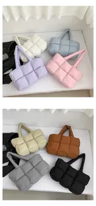 Close-up of quilted puffer tote bags in multiple colors with square padded texture