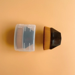 Flat top foundation brush with dense golden brown bristles and a black faceted handle