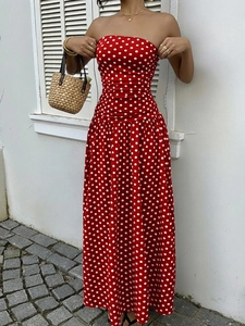 Detail of red off-shoulder polka dot maxi dress featuring elegant pleated waist and slim fit