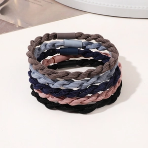 Detailed macro view of 5-piece braided elastic hair ties in assorted matte colors