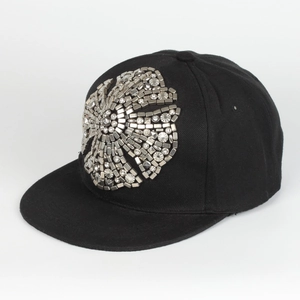 Detail of silver metallic studs and crystal rhinestones on a black hip hop baseball cap