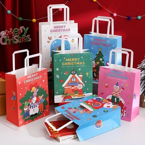 Close-up of assorted Christmas gift bags featuring festive snowman and reindeer illustrations