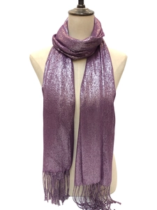 Detail of purple evening scarf with glitter threads and long fringed edges on mannequin