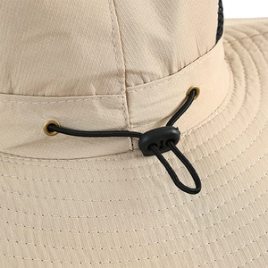 Close-up of khaki sun hat featuring adjustable elastic drawstring and metal eyelet detail